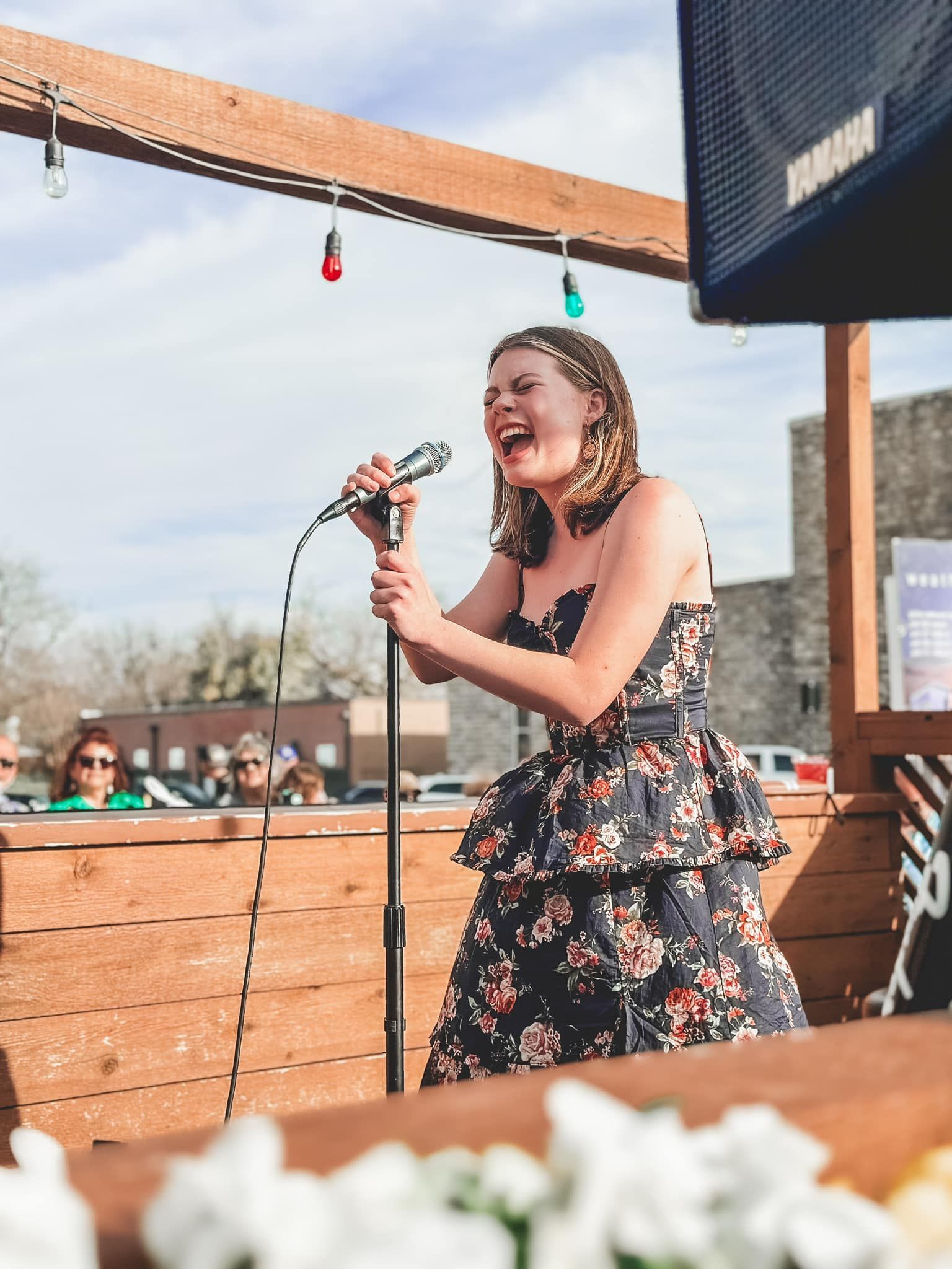 A woman and a girl are standing next to each other holding a trophy.
