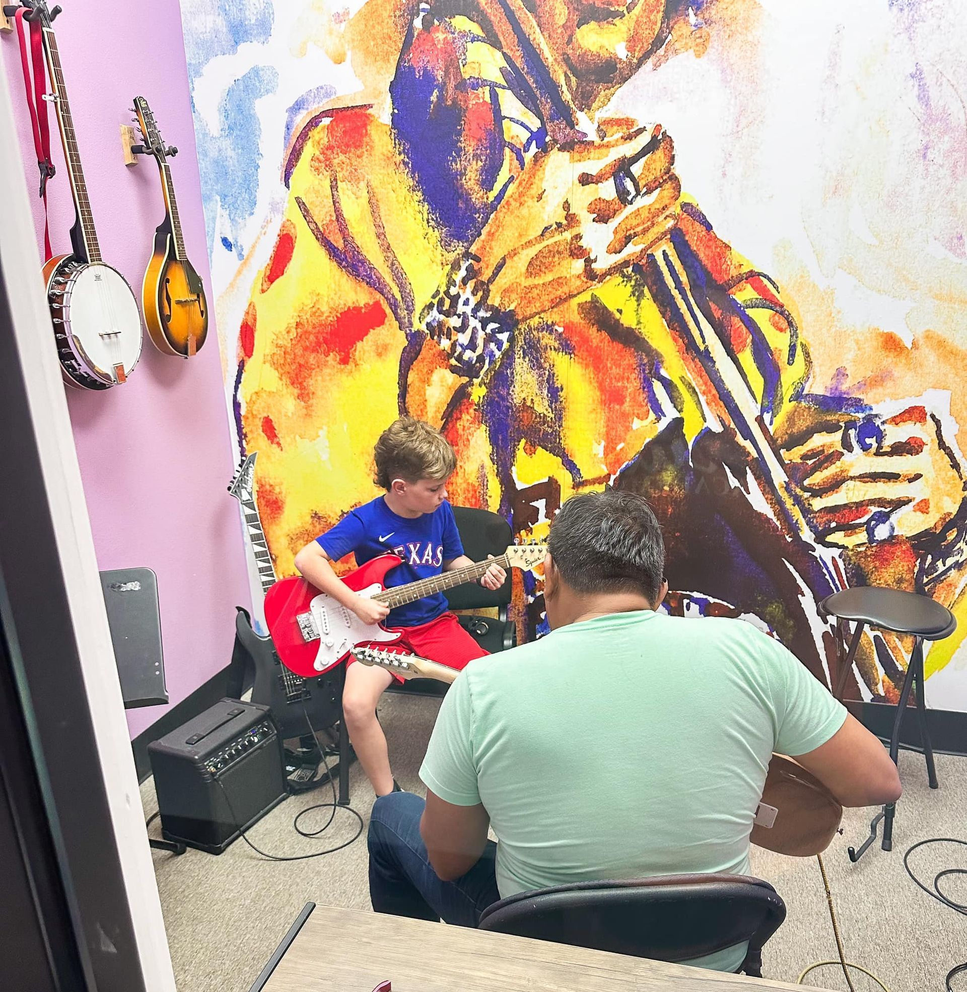 A young girl is playing a keyboard and smiling.