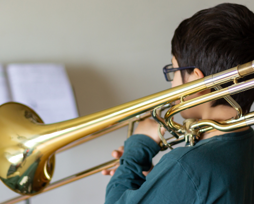 A group of people are playing a piano together.