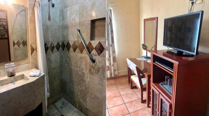 Un baño con ducha a ras de suelo y televisión.