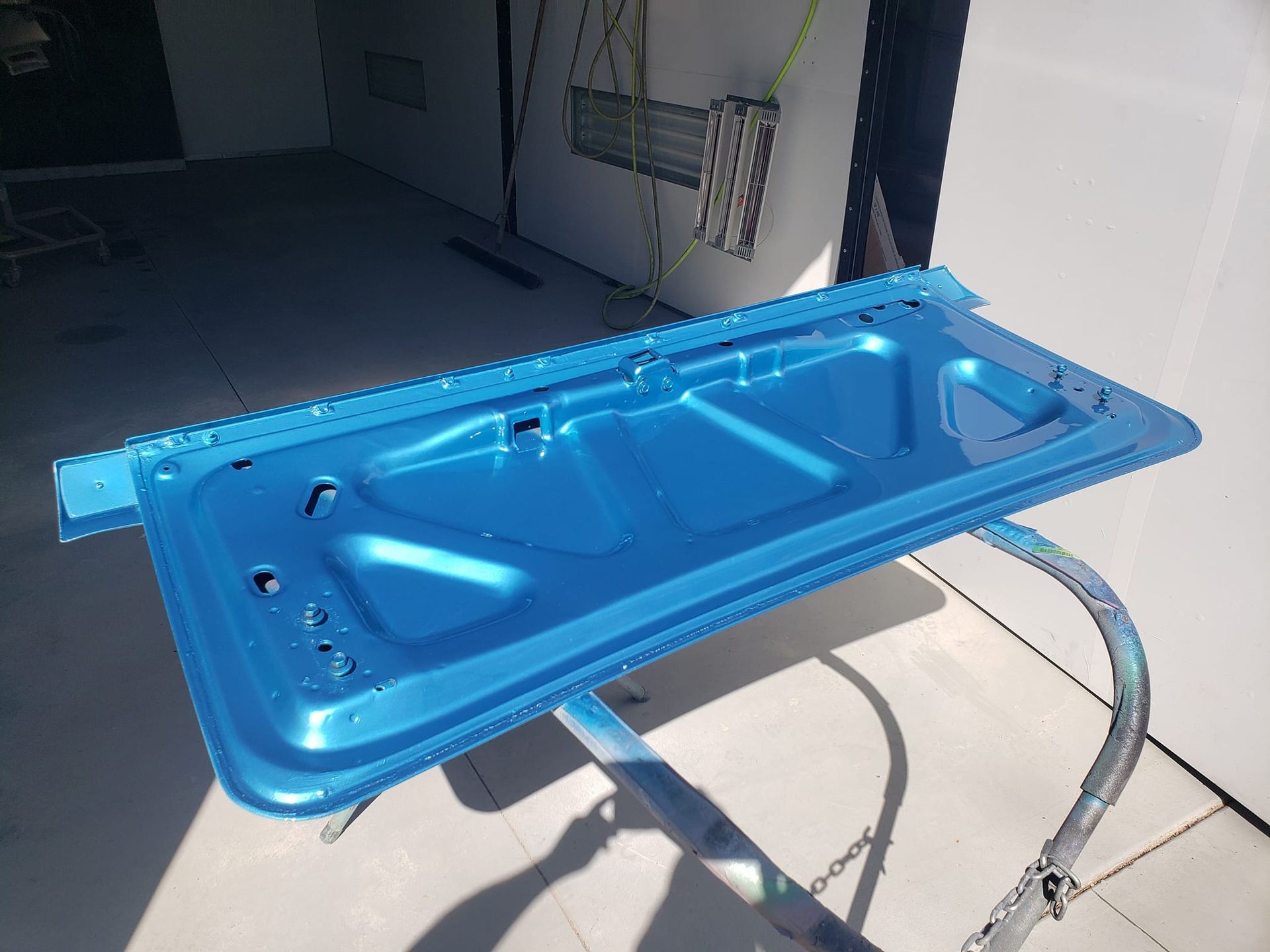 A blue door is sitting on top of a metal stand.