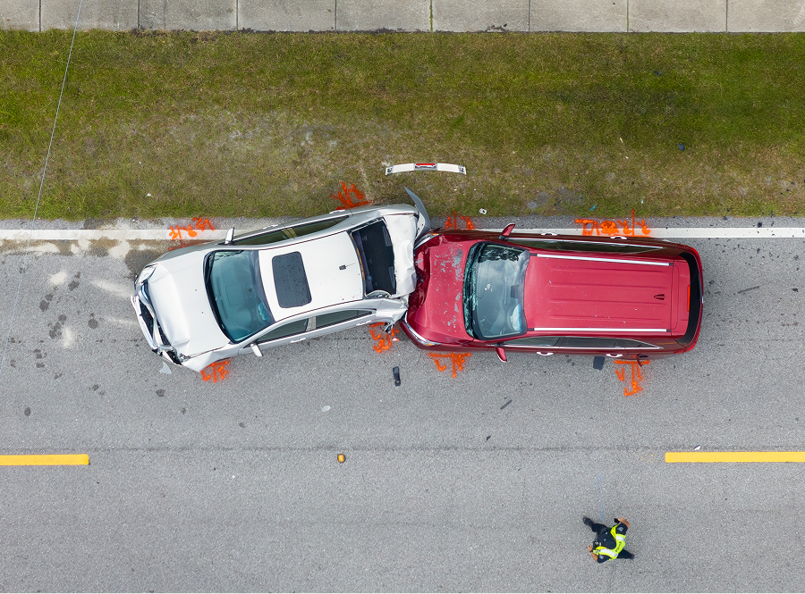An aerial view of a car accident on a road