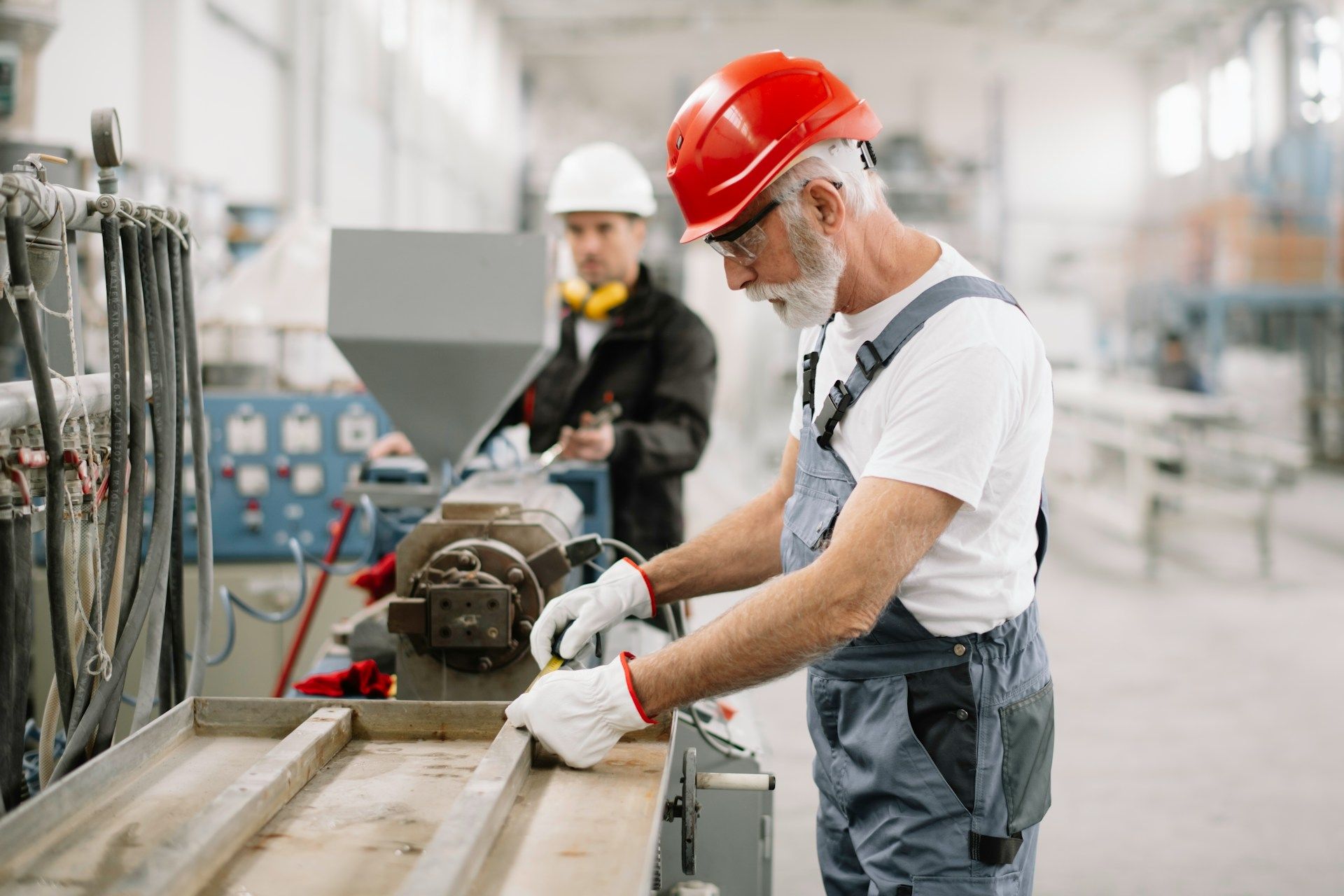 A man is working on a machine in a factory.