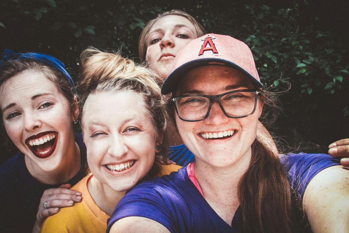A group of young women are taking a selfie together.