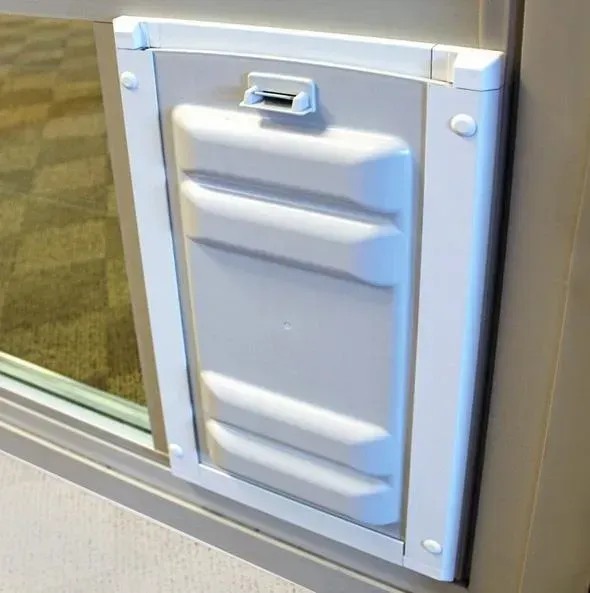 White pet door installed in a glass window.