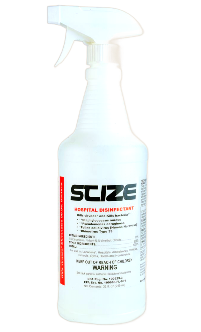 A spray bottle is sitting on a rock next to a river.