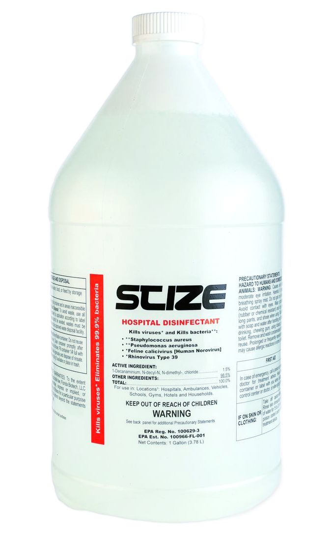 A bottle of scize sits on a rock near a river