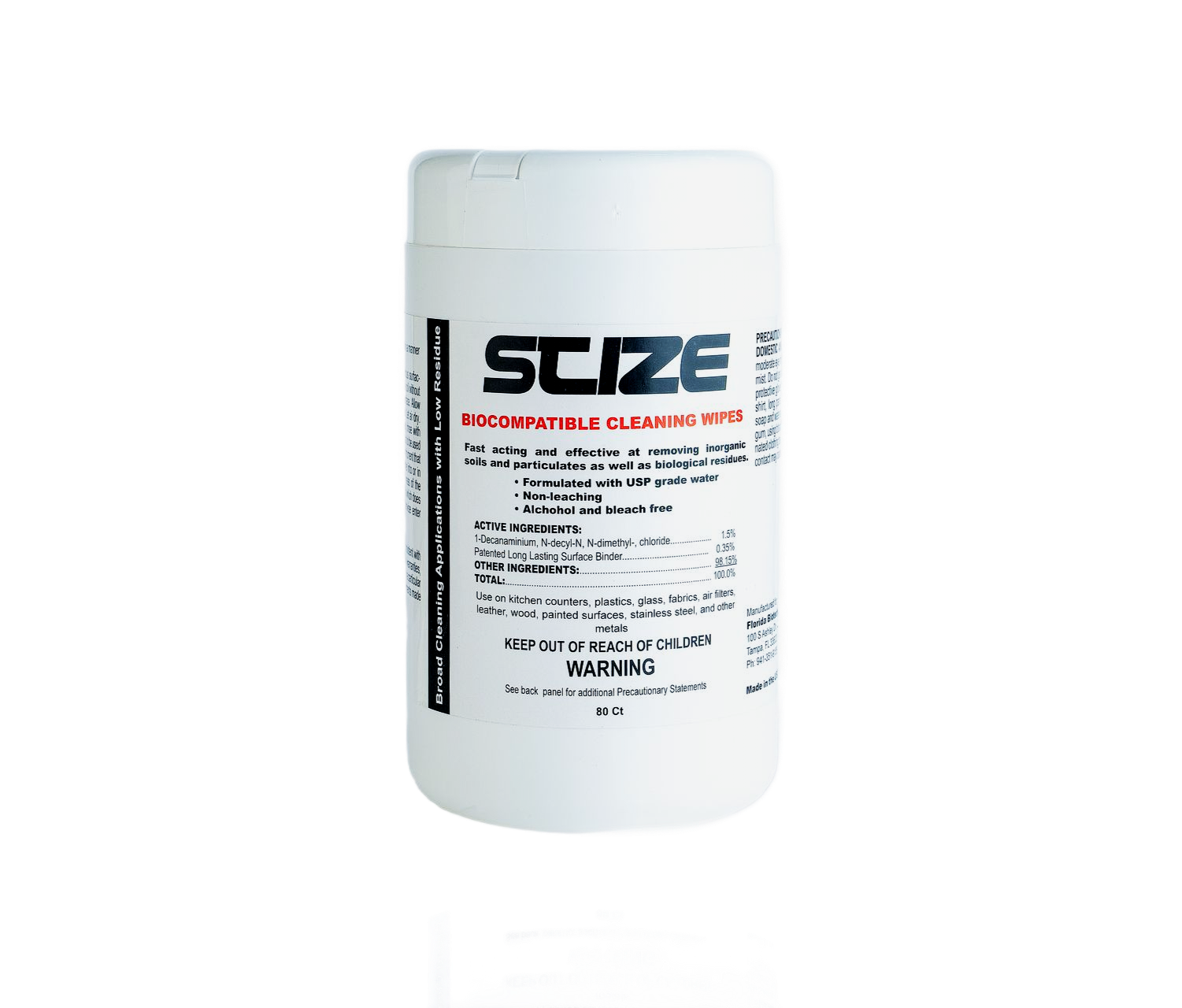 A bottle of suze hand sanitizer is sitting on a rock.