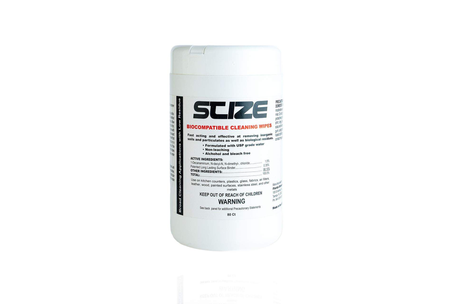 A bottle of suze hand sanitizer is sitting on a rock.