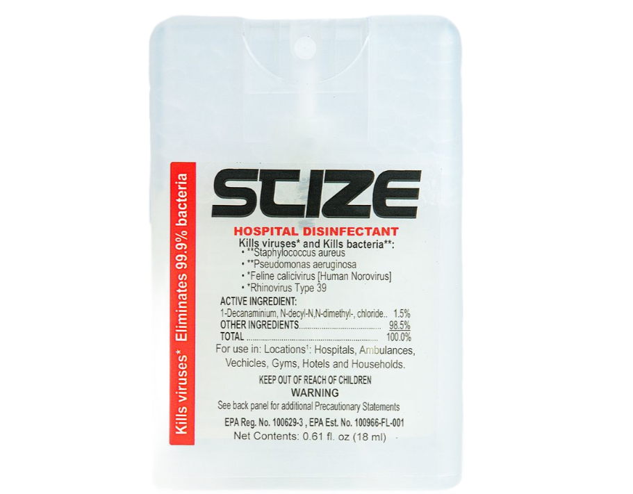 A bottle of suze hand sanitizer is sitting on a rock.