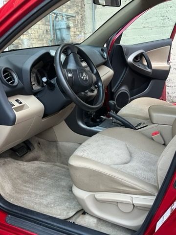The interior of a red car with the door open