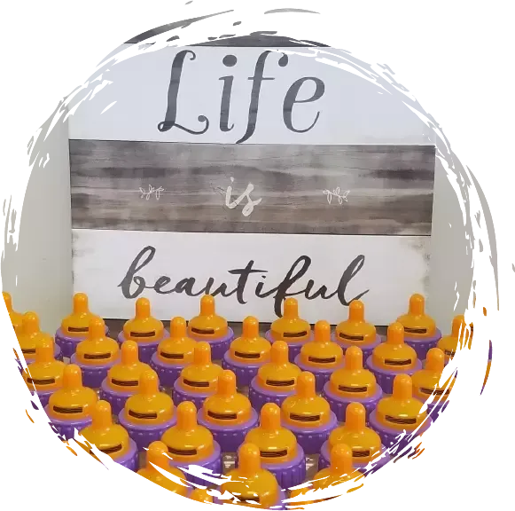 a sign that says life is beautiful is surrounded by purple pacifiers