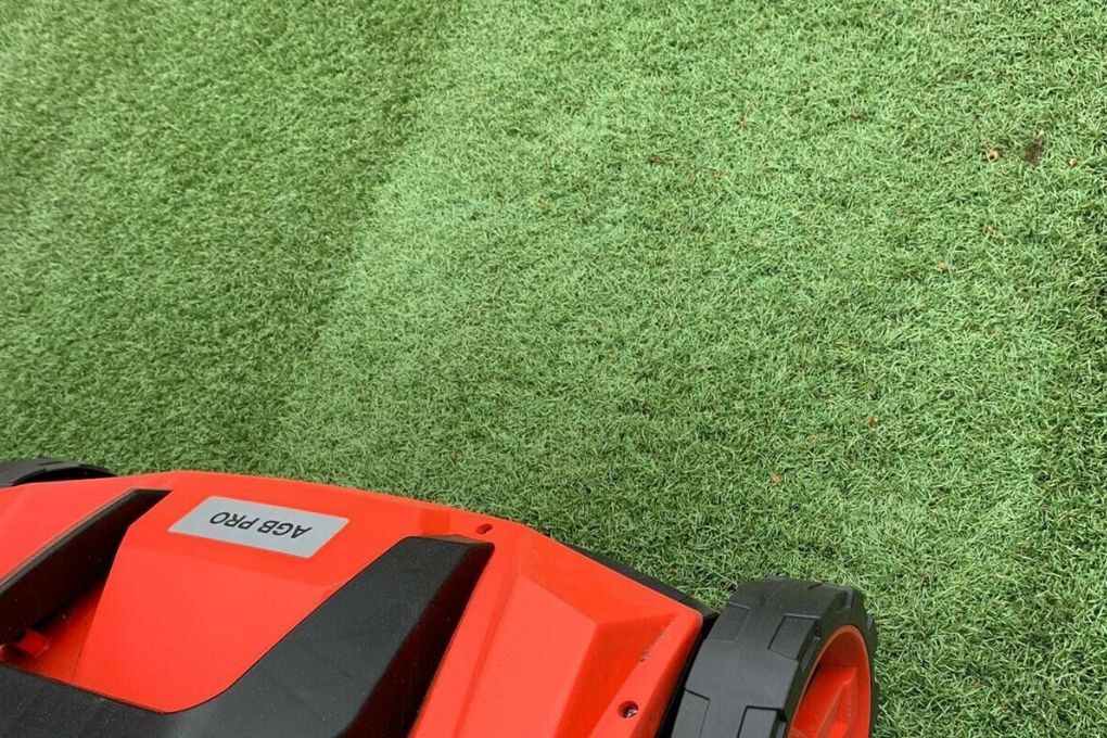 Artificial Grass Coventry using an artificial grass power brush to lift the fake grass piles