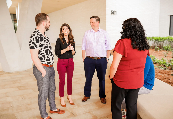 Flexion point team standing and talking.