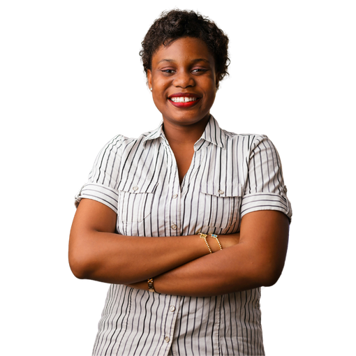 A woman in a striped shirt is standing with her arms crossed and smiling.