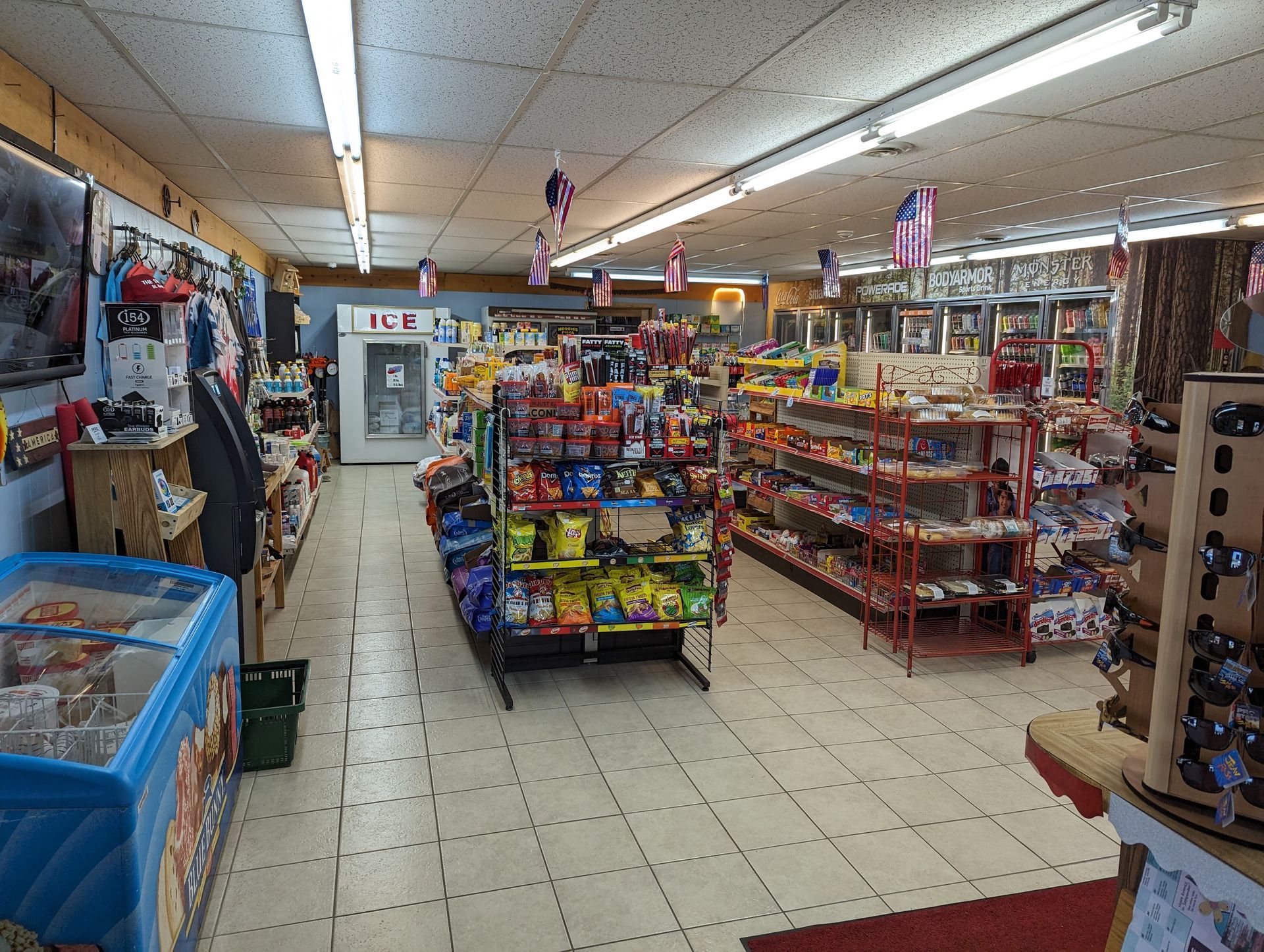 The inside of a grocery store with a vending machine in the back