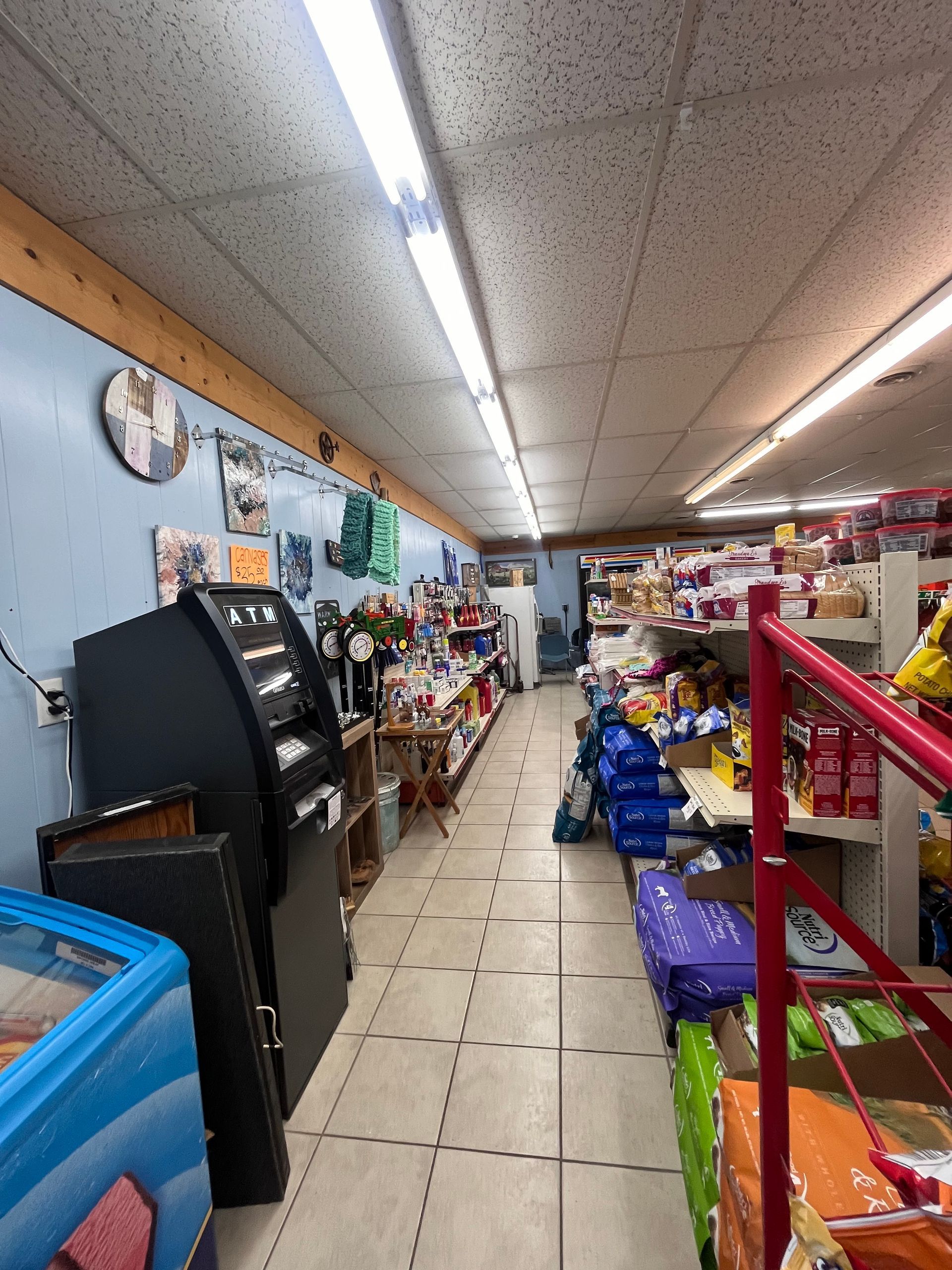 A long hallway in a store filled with lots of products.