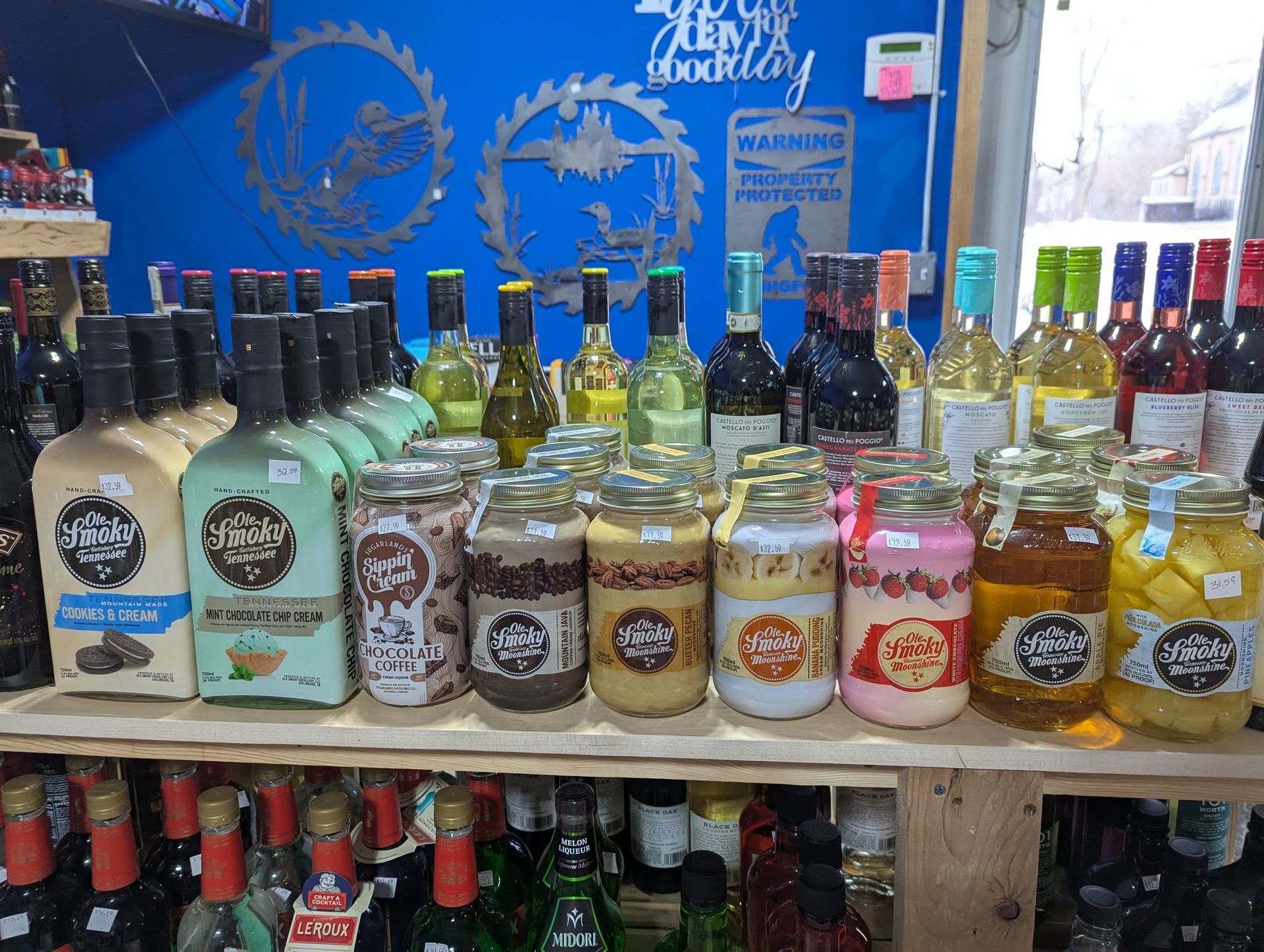 A shelf filled with bottles and jars of liquor.
