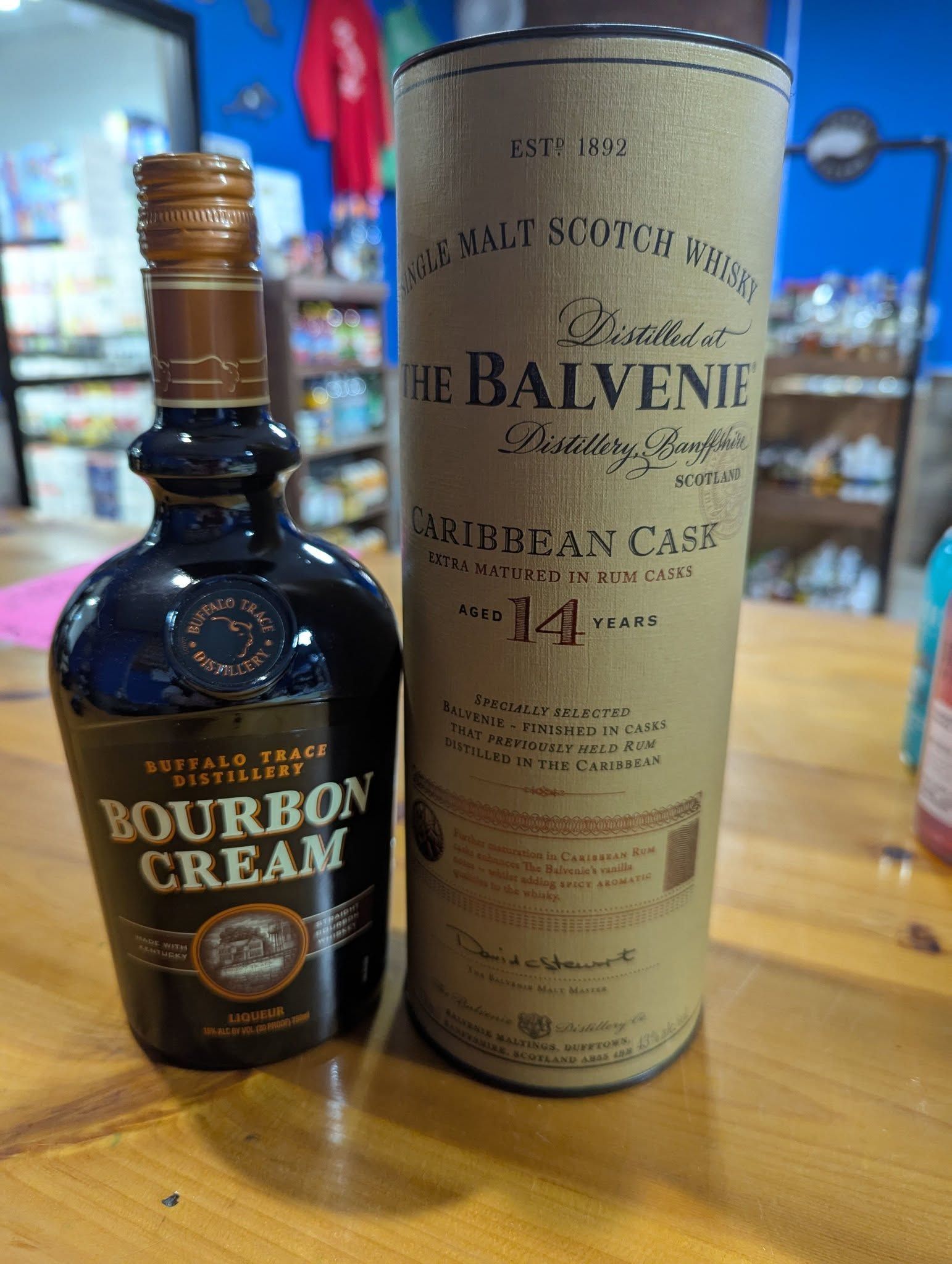 A bottle of bourbon cream next to a bottle of balvenie whisky