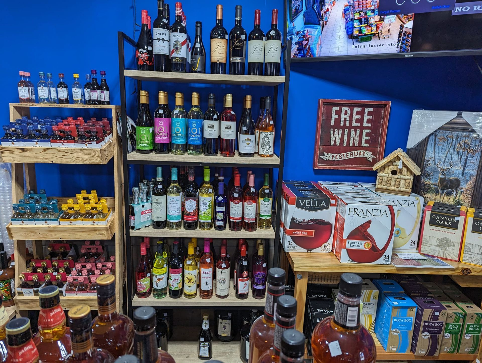 A store filled with lots of wine bottles and a sign that says free wine