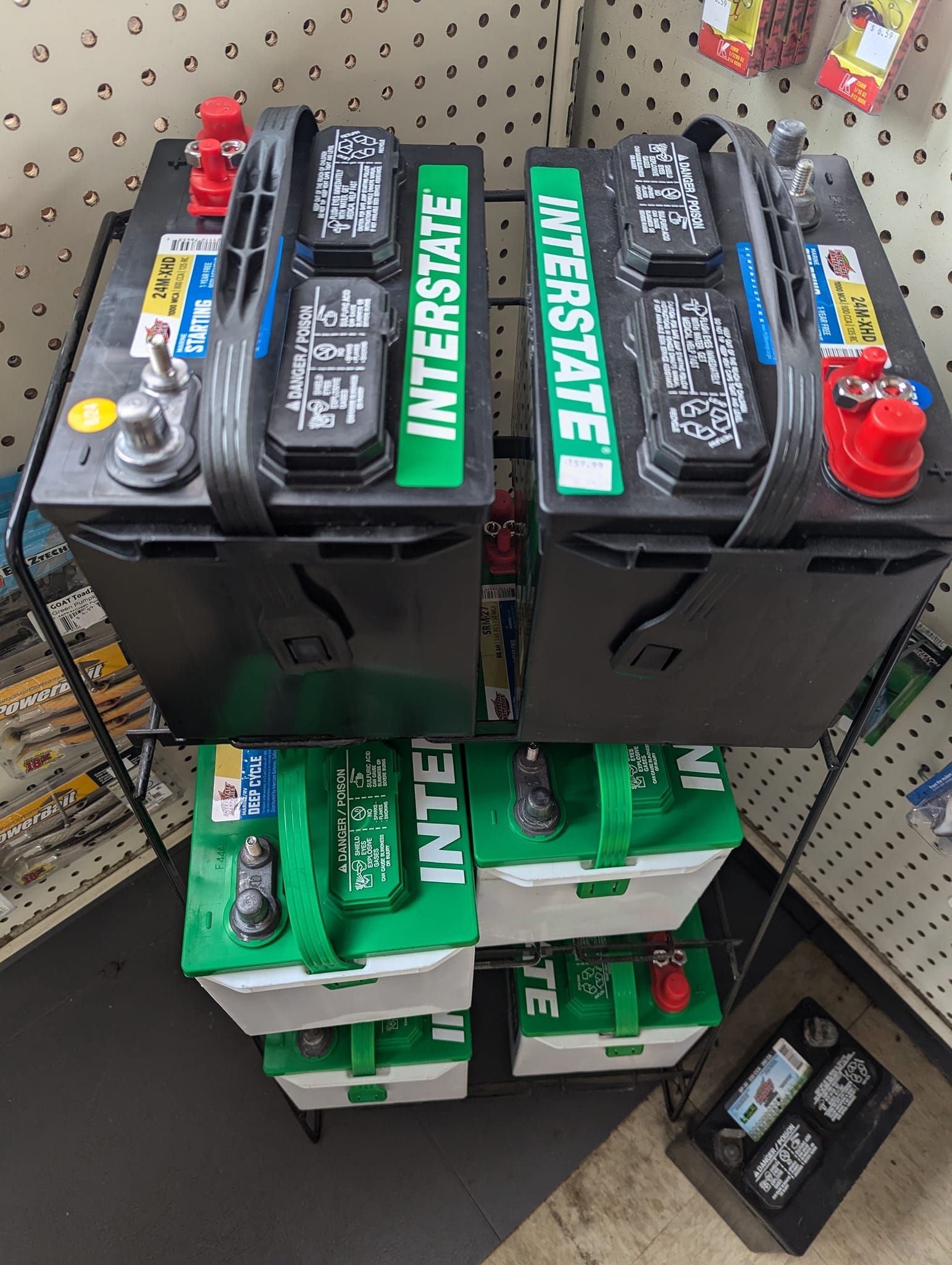 Two interstate batteries are stacked on top of each other in a store.