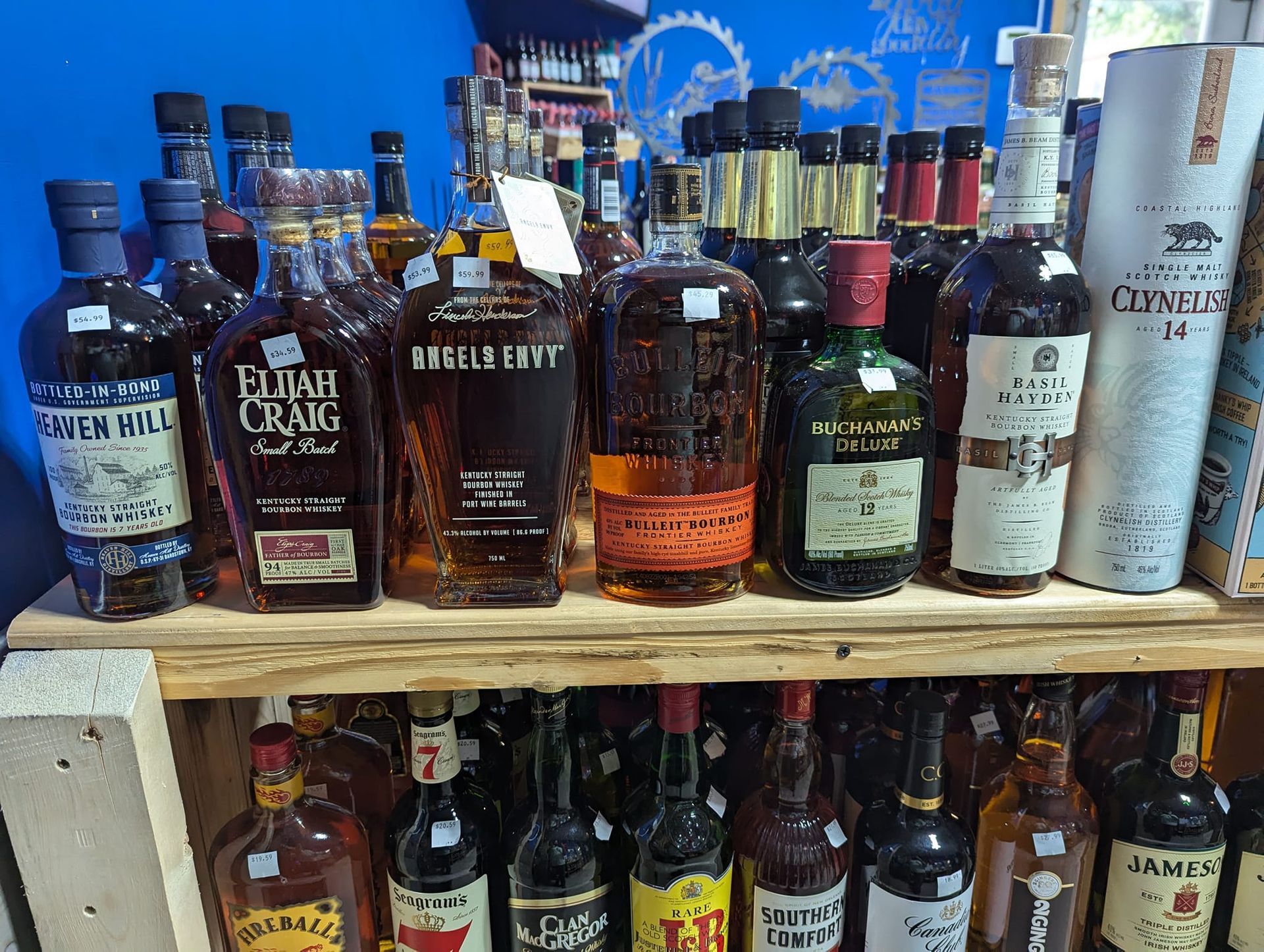 A shelf filled with lots of bottles of liquor