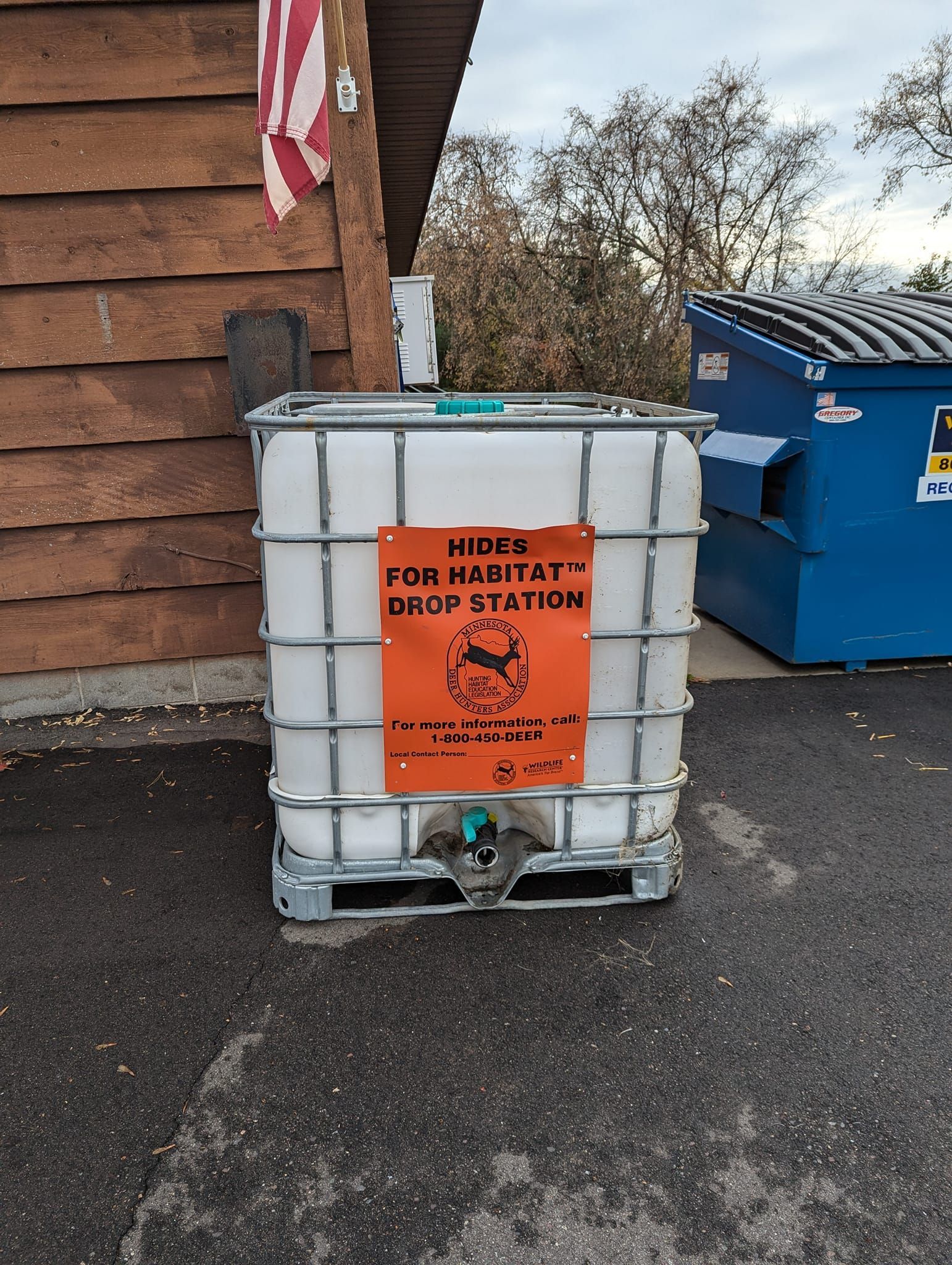A large white container with an orange sticker on it that says 