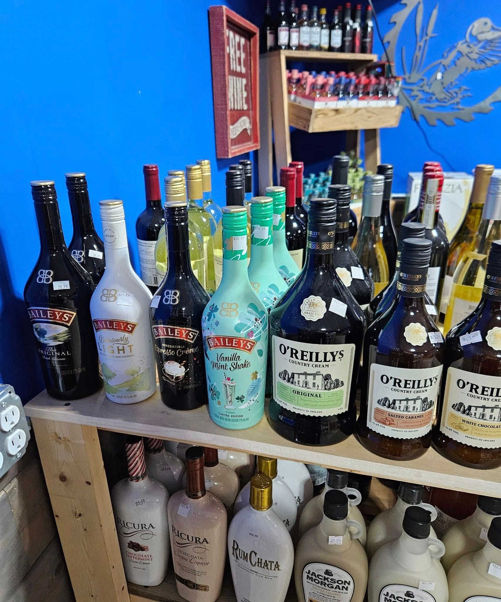 A shelf filled with lots of bottles of liquor