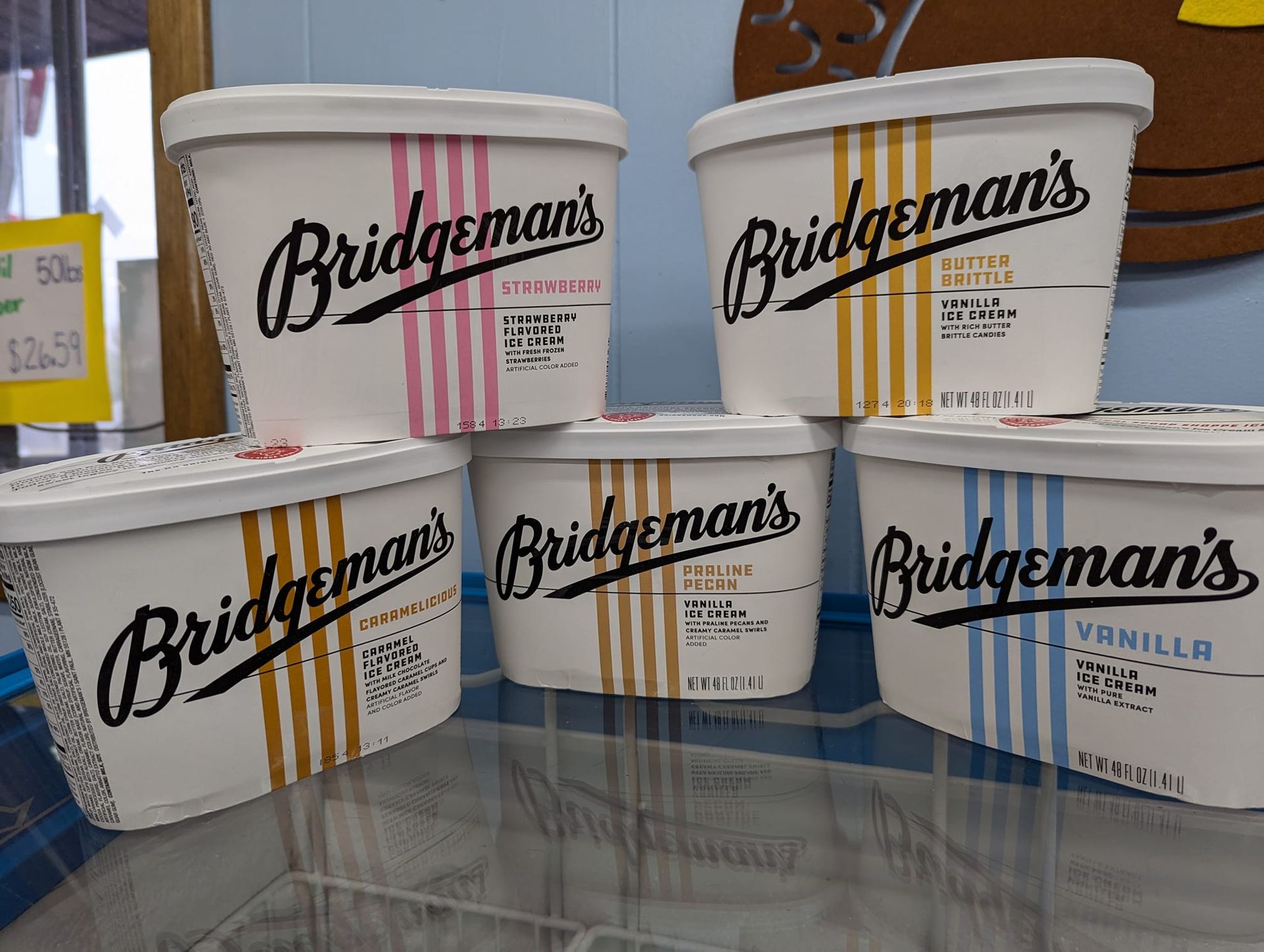 Several containers of bridgeman 's ice cream are stacked on top of each other