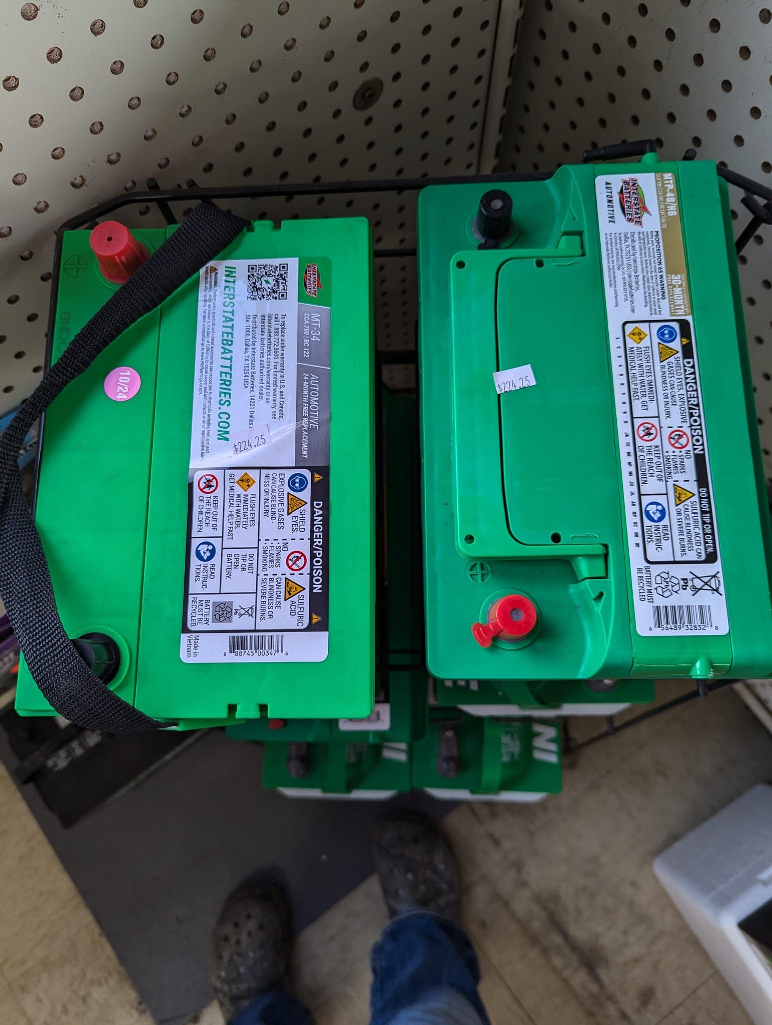 Two green batteries are stacked on top of each other
