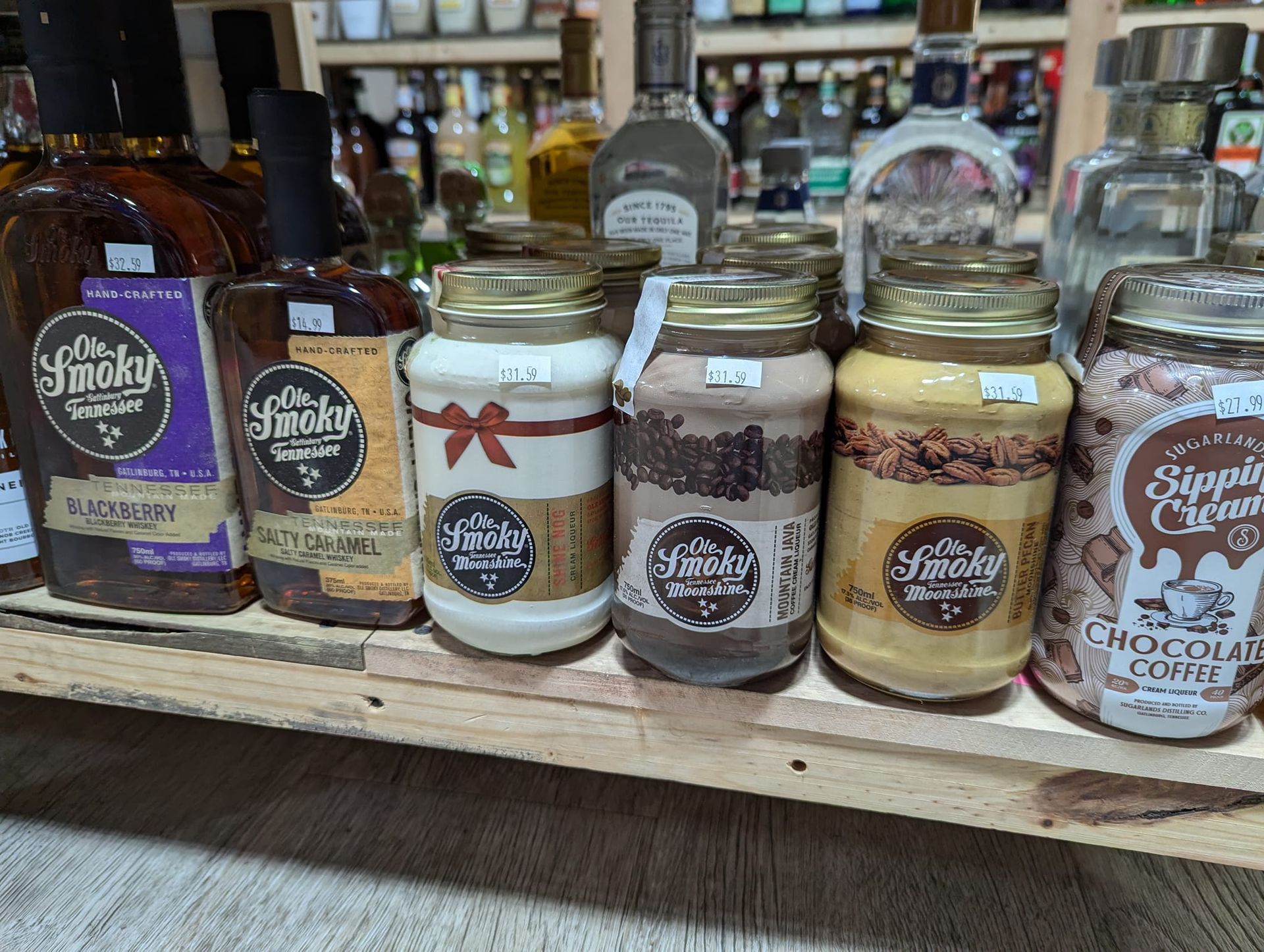 A shelf filled with jars of food and liquor.