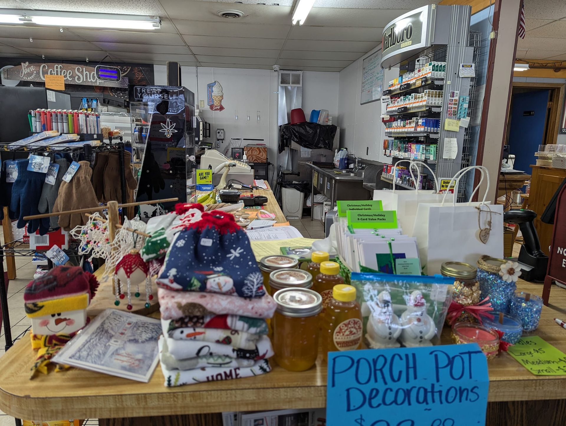 A table in a store with a sign that says porch pot decorations