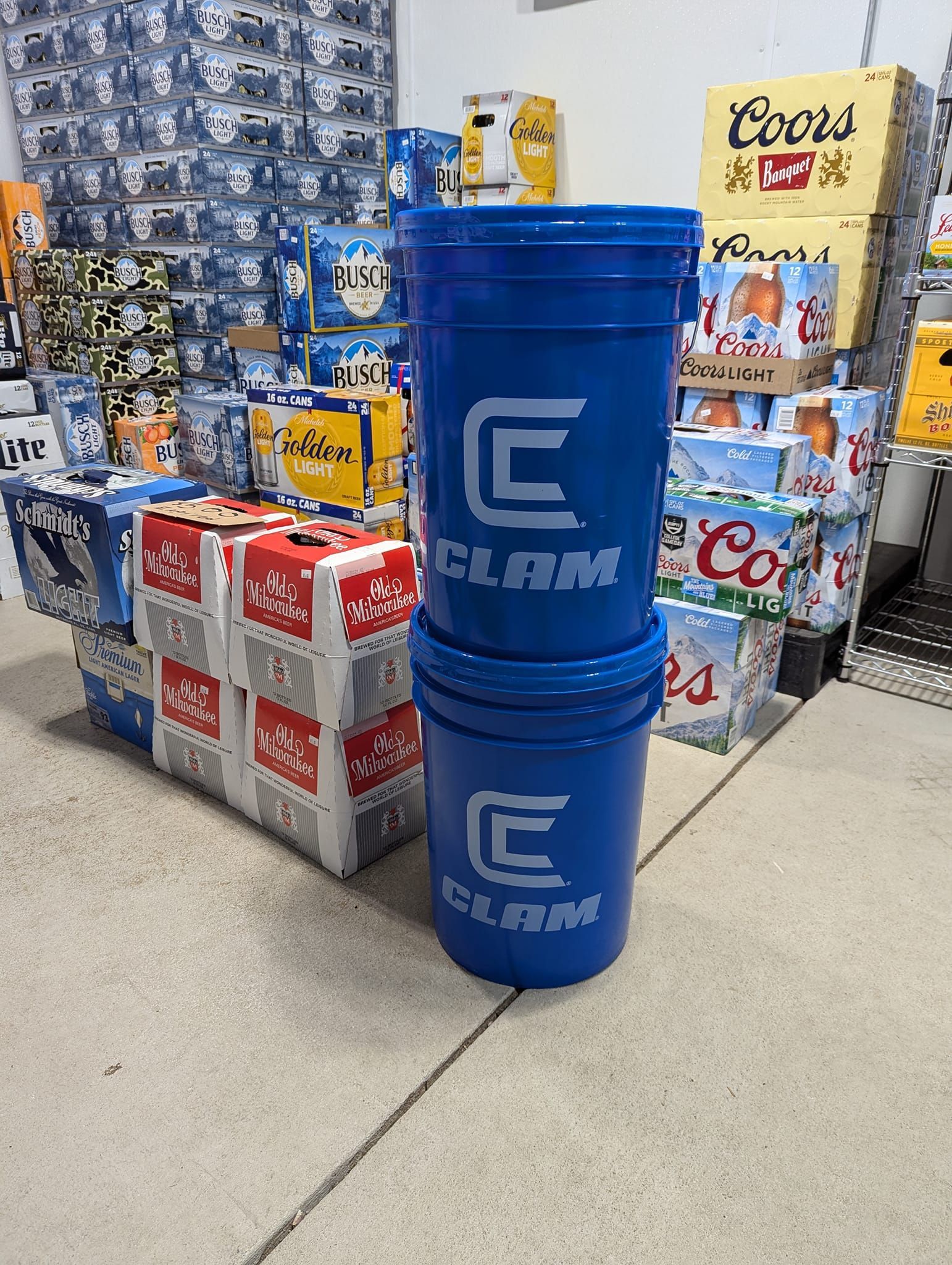 Three blue buckets are stacked on top of each other in a store.
