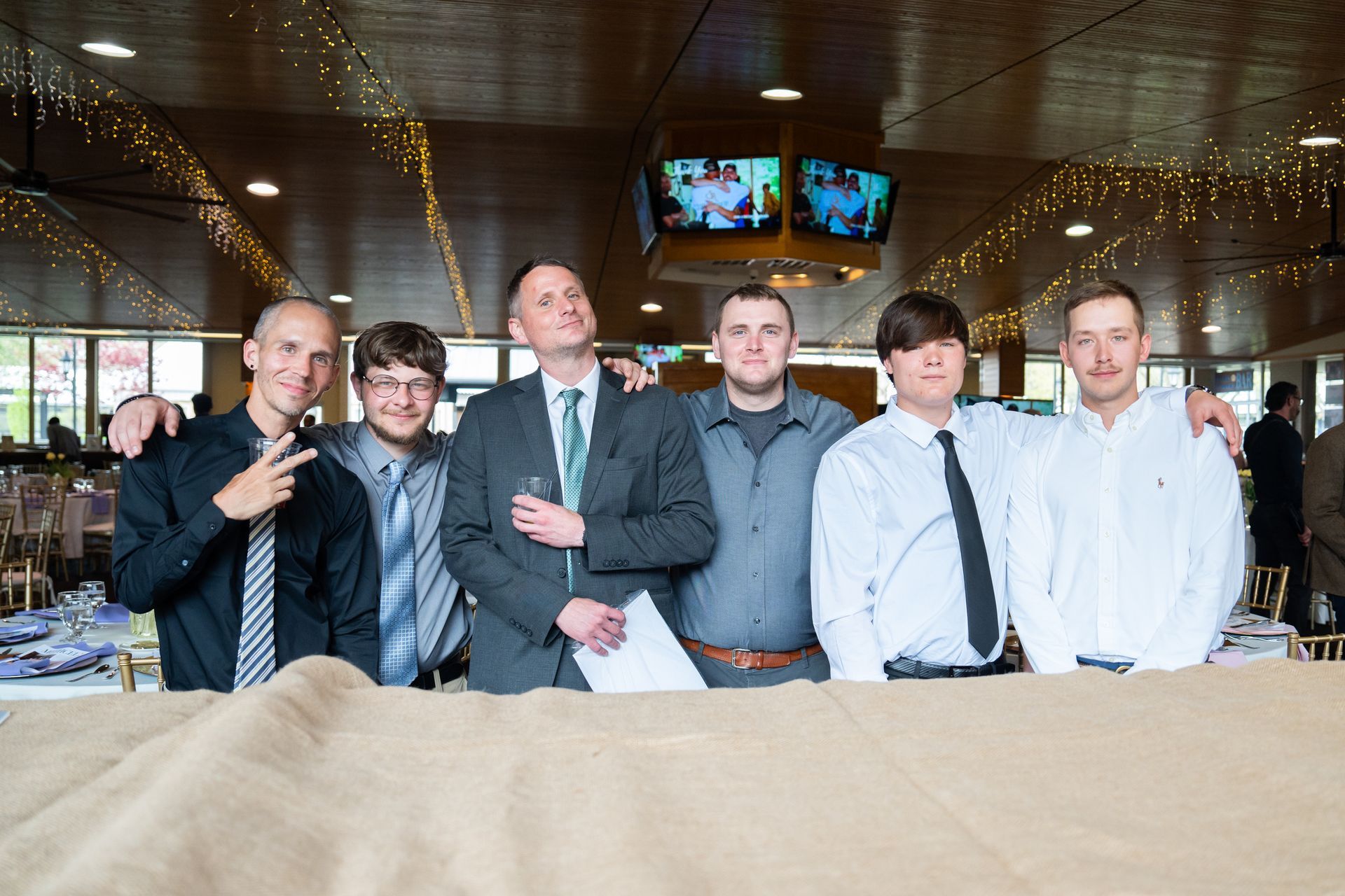 A group of men are posing for a picture in a restaurant.