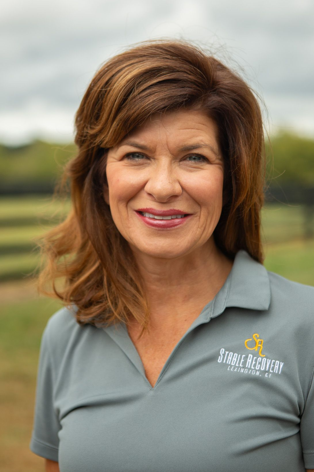A man wearing glasses and a hat that says poker for ponies