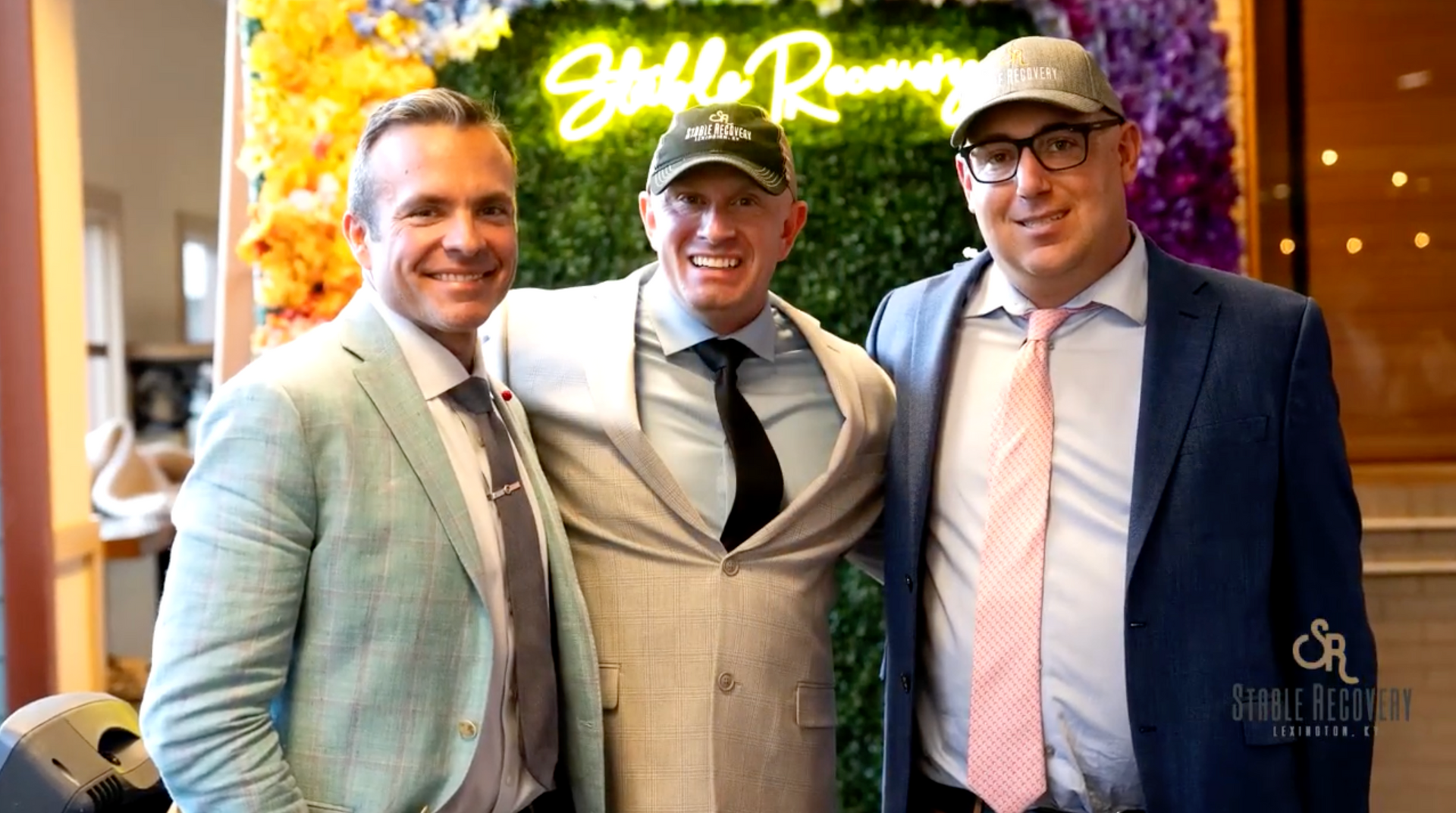Three men in suits and ties are posing for a picture.