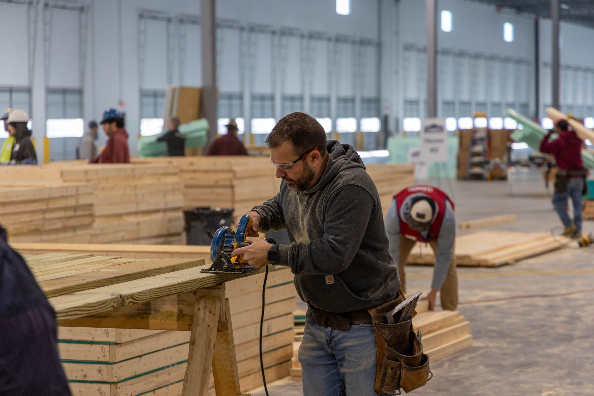 A man is working on a piece of wood in a factory.