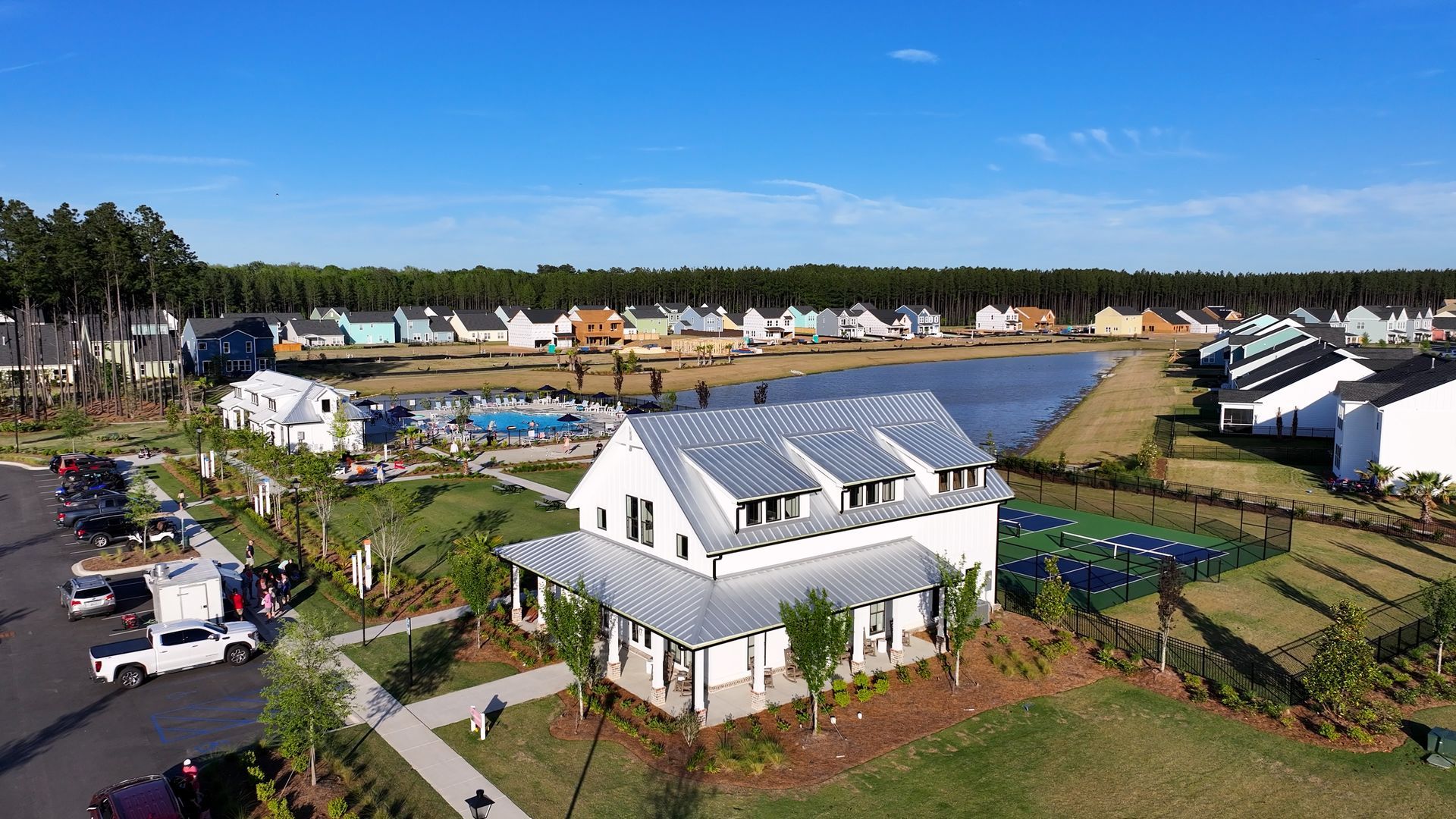 An aerial view of a residential area with a lake in the background.