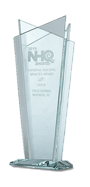 A clear glass trophy with the word nhq on it.