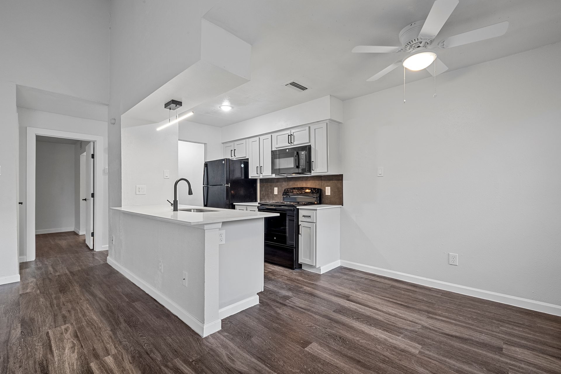 Photo showing a kitchen and the dining area next to it