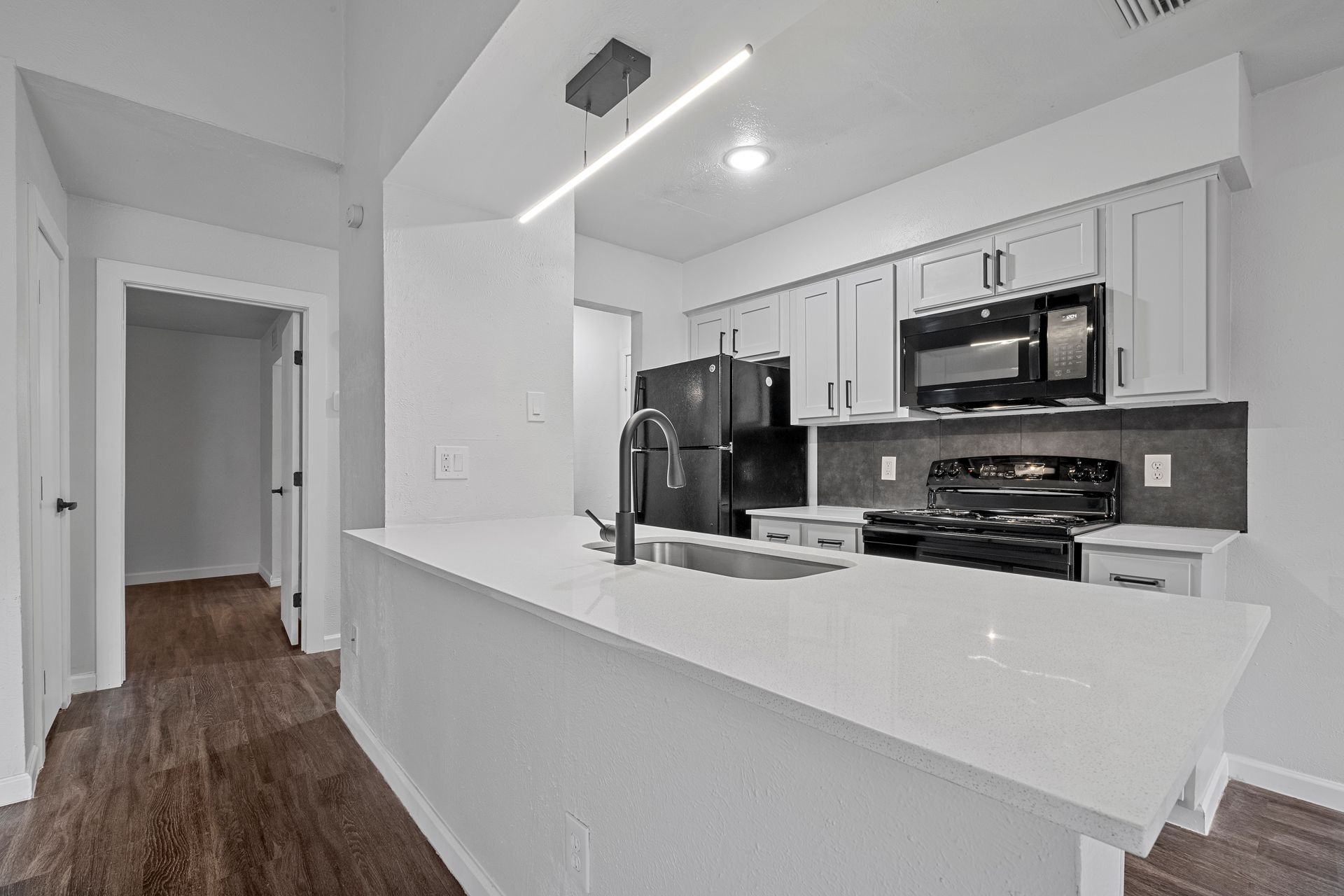 Photo showing a kitchen with a barstool area