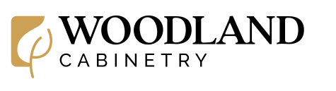 Logo for Woodland Cabinetry featuring a gold leaf design and black text on a white background.