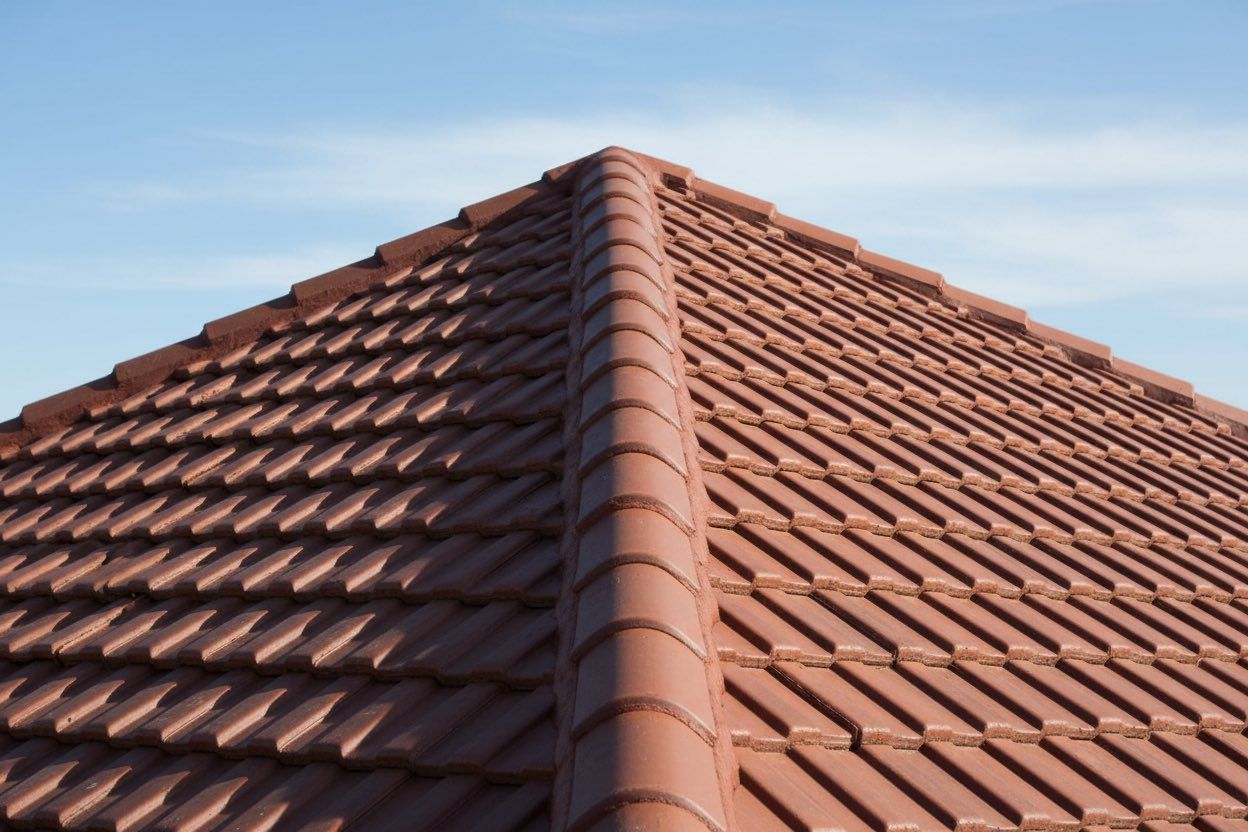 Brown tiled roof against a blue sky.
