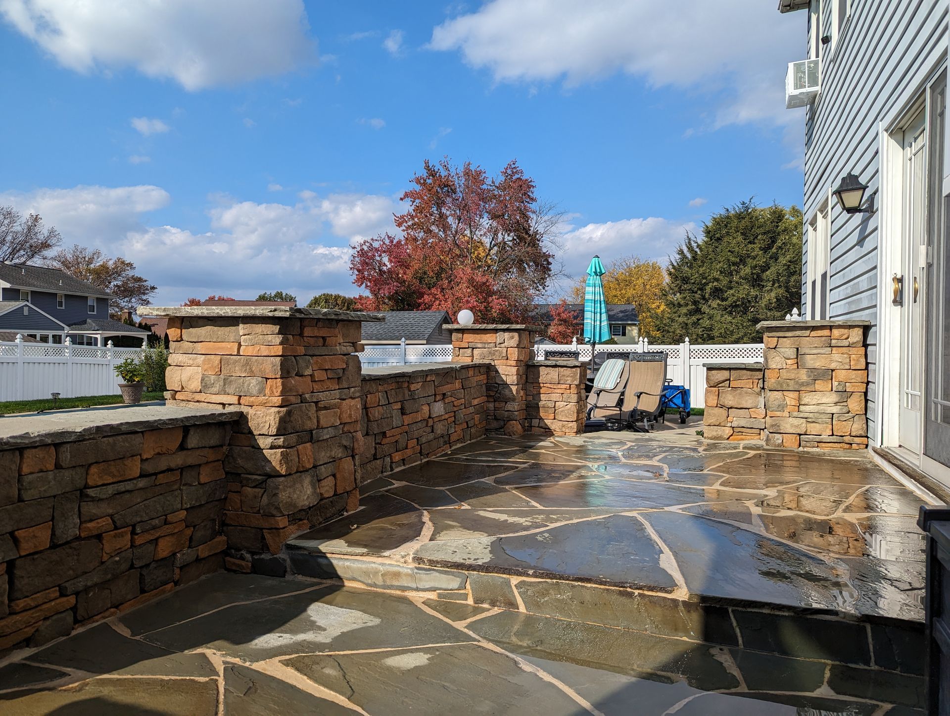 Stone patio with built-in stone walls and pillars.