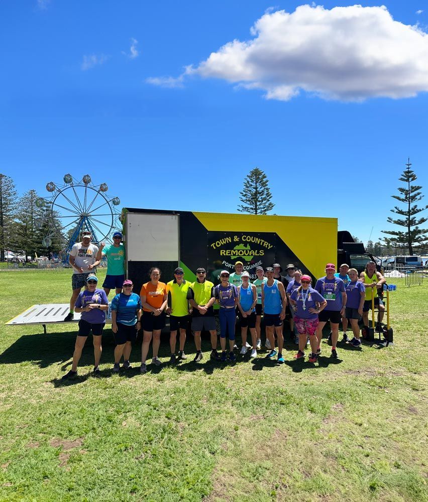 Team group Photo with the Service Mobile — Town & Country Removals In Port Macquarie, NSW