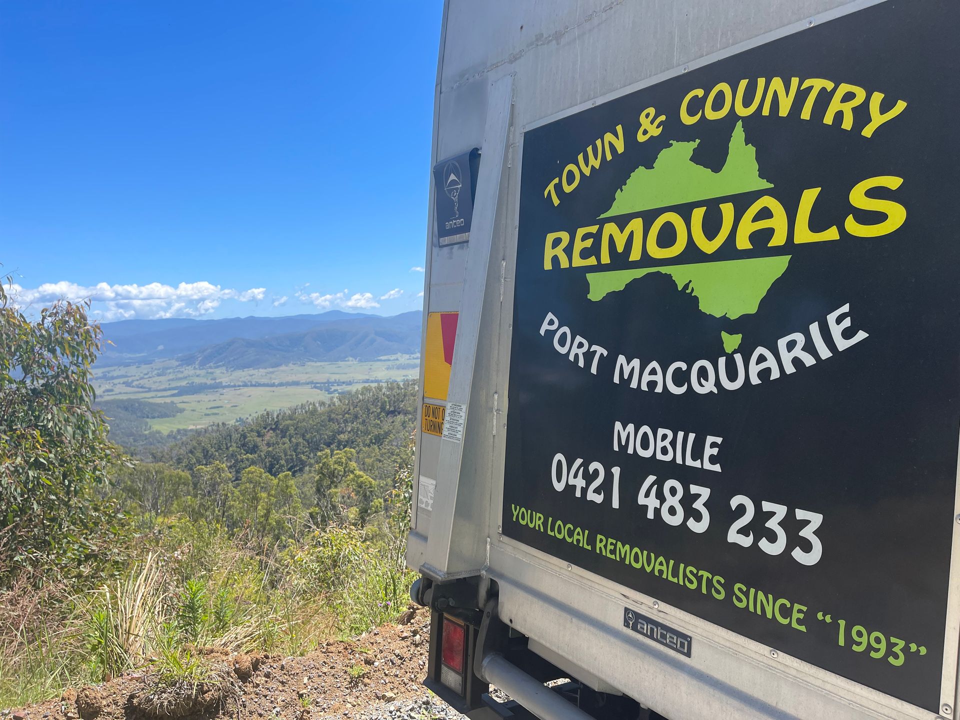 A Moving Truck Parked in a Hill with The View of the Land — Town & Country Removals In Port Macquarie, NSW