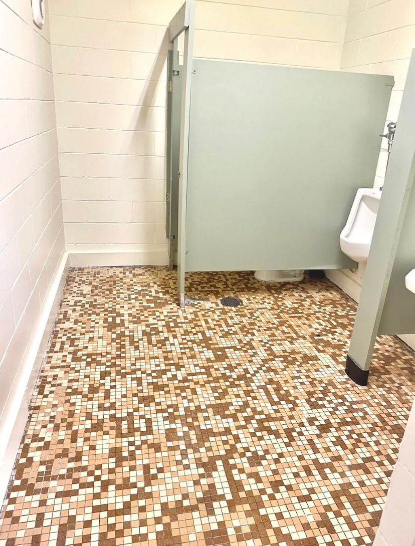 A bathroom with a mosaic floor and a urinal. BEFORE/AFTER