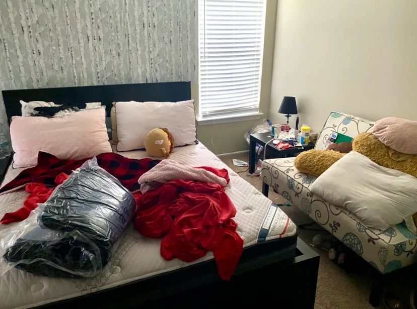 A bedroom with a bed , couch , nightstand and a window. BEFORE/AFTER