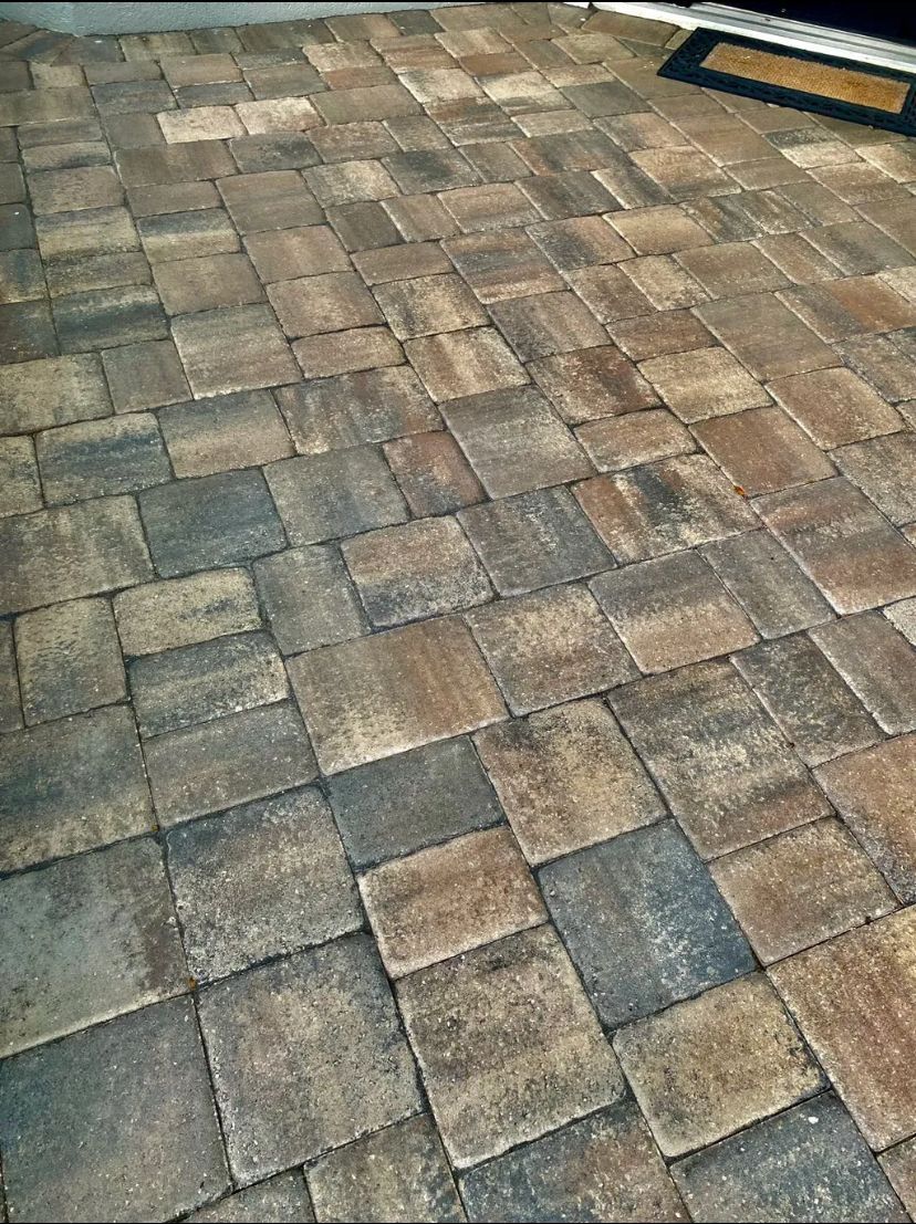 A close up of a brick floor with a door mat on it. BEFORE/AFTER