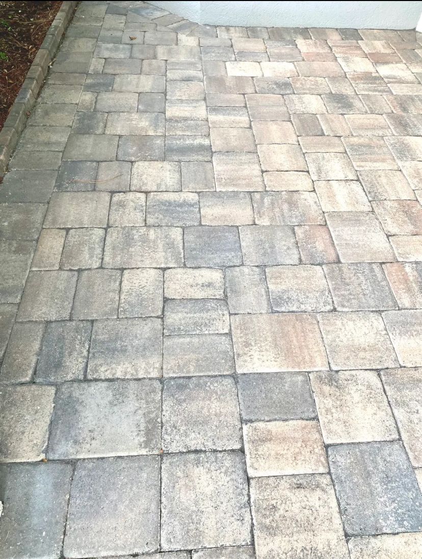 A close up of a brick walkway leading to a house. BEFORE/AFTER